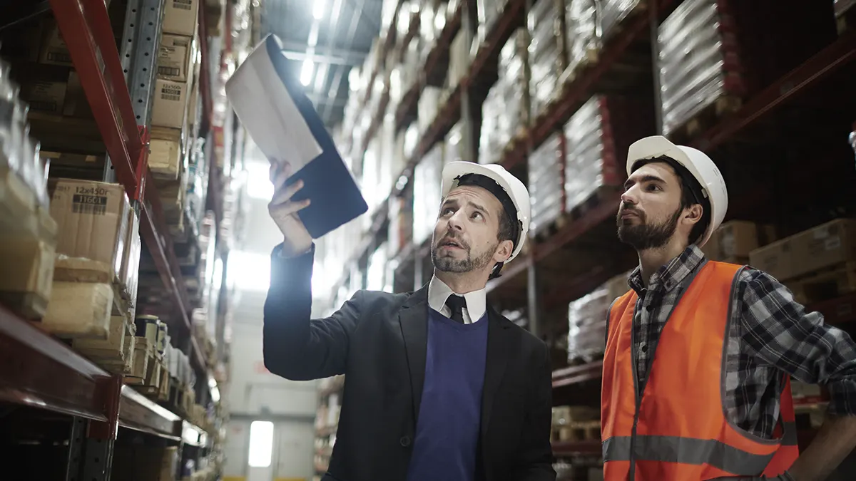 Worried workers auditing warehouse shelving